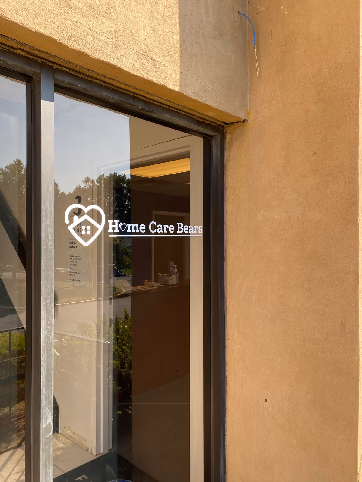 Glass door entrance with Home Care Bears logo on the glass.