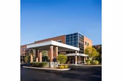 Glenview Terrace front entrance of a brick senior living facility with landscaping.