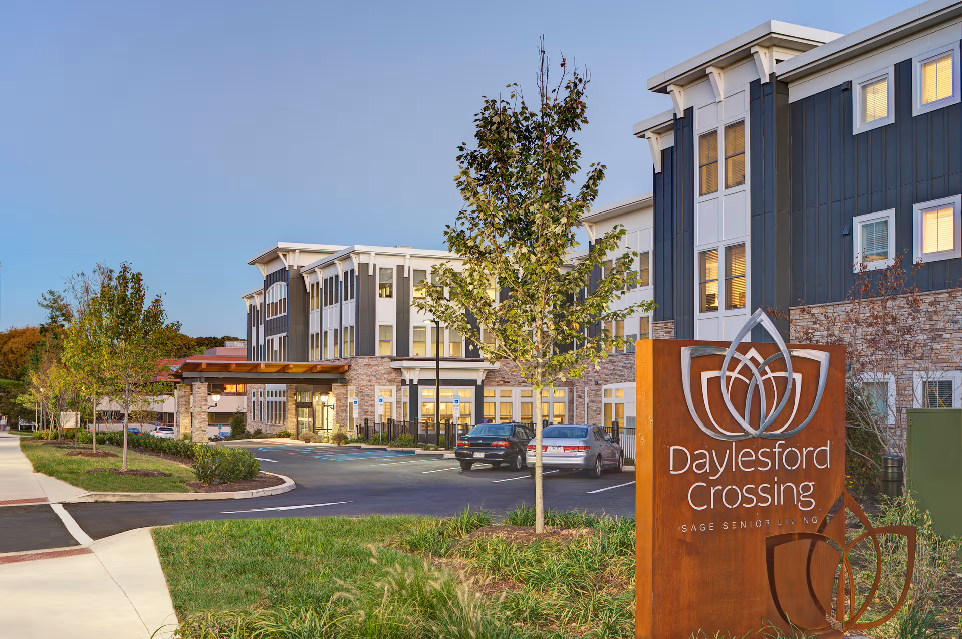 Exterior view of Daylesford Crossing senior living campus with a large front sign and landscaping.
