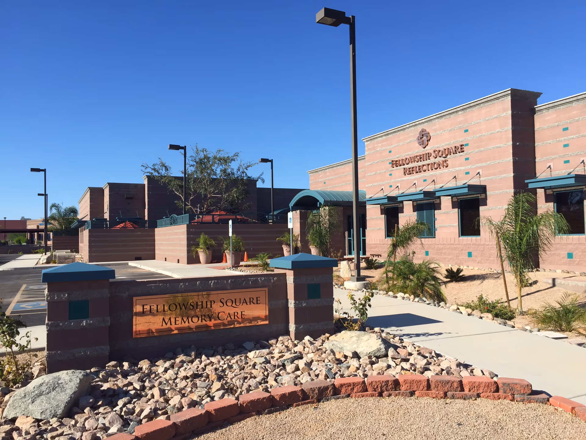 Exterior view of Fellowship Square Memory Care in Mesa, showing brick building and desert landscaping.