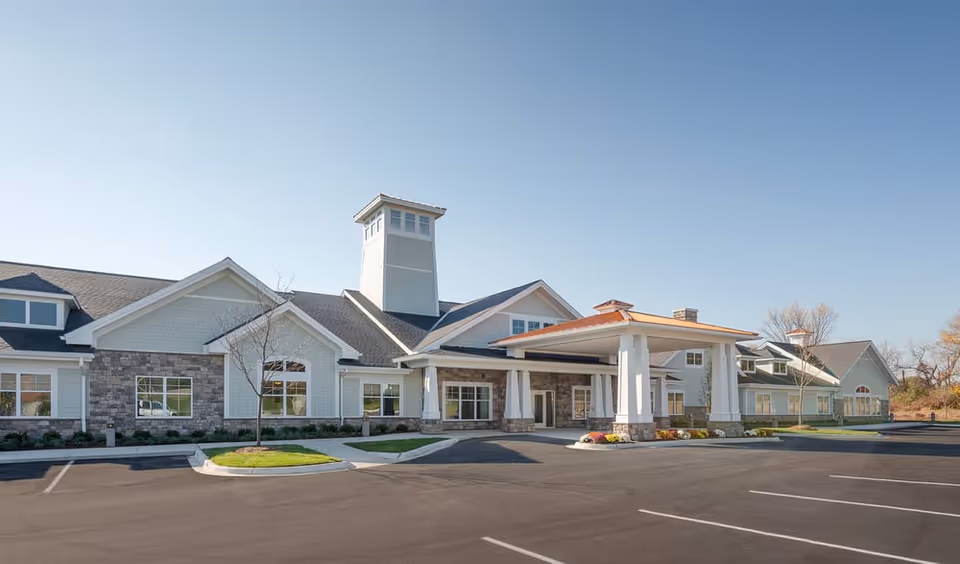 Beacon Square Living exterior building with entrance canopy and empty parking lot.