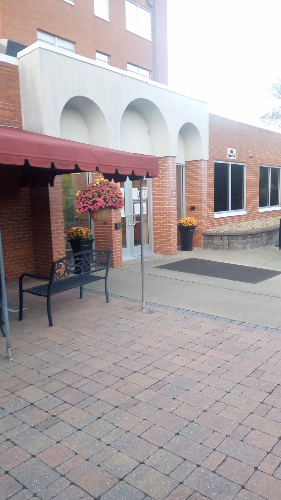 Exterior view of Townview Health and Rehabilitation Center with brick facade, arches, and entrance.
