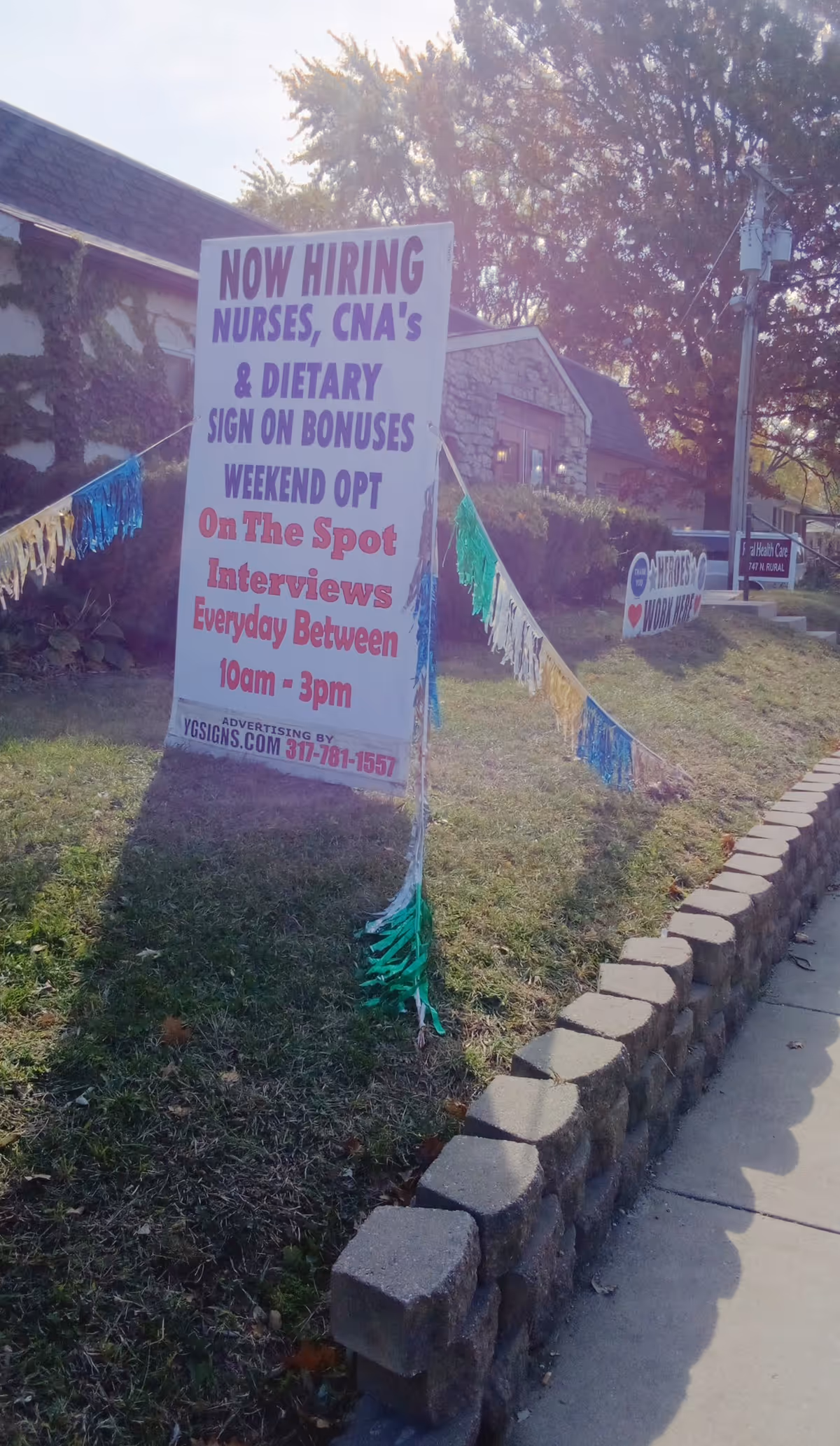 Outdoor sign advertising job openings outside Rural Health Care Center