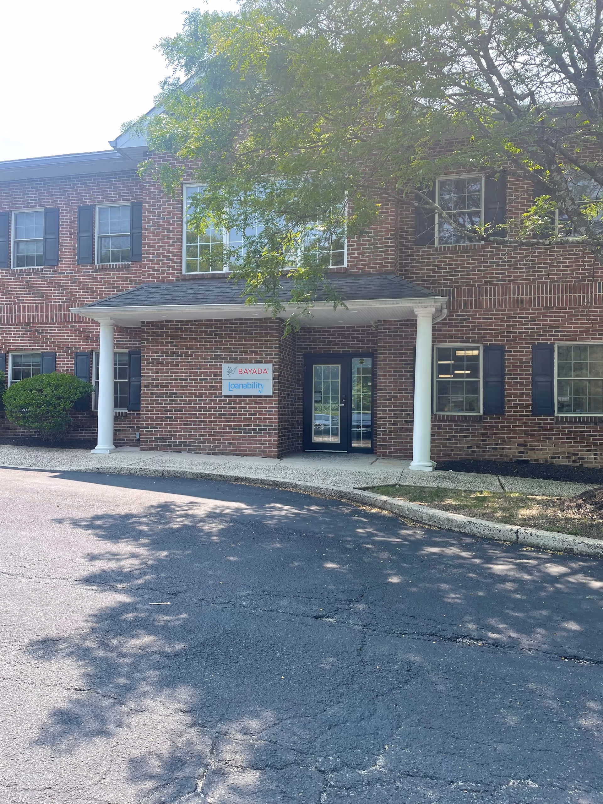 Brick exterior of a facility with a covered entrance and BAYADA Staffing sign.