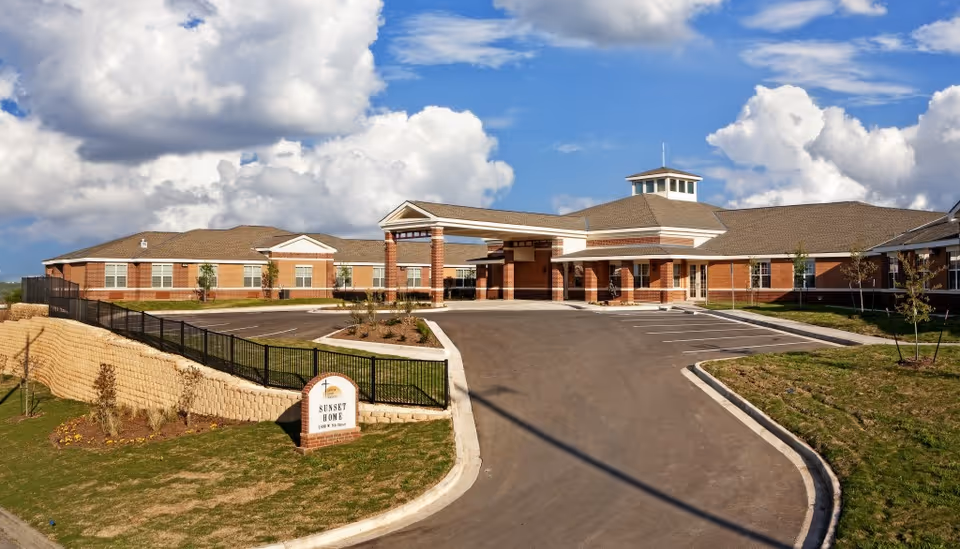 Exterior view of Lakeside Manor assisted living building with driveway and parking.