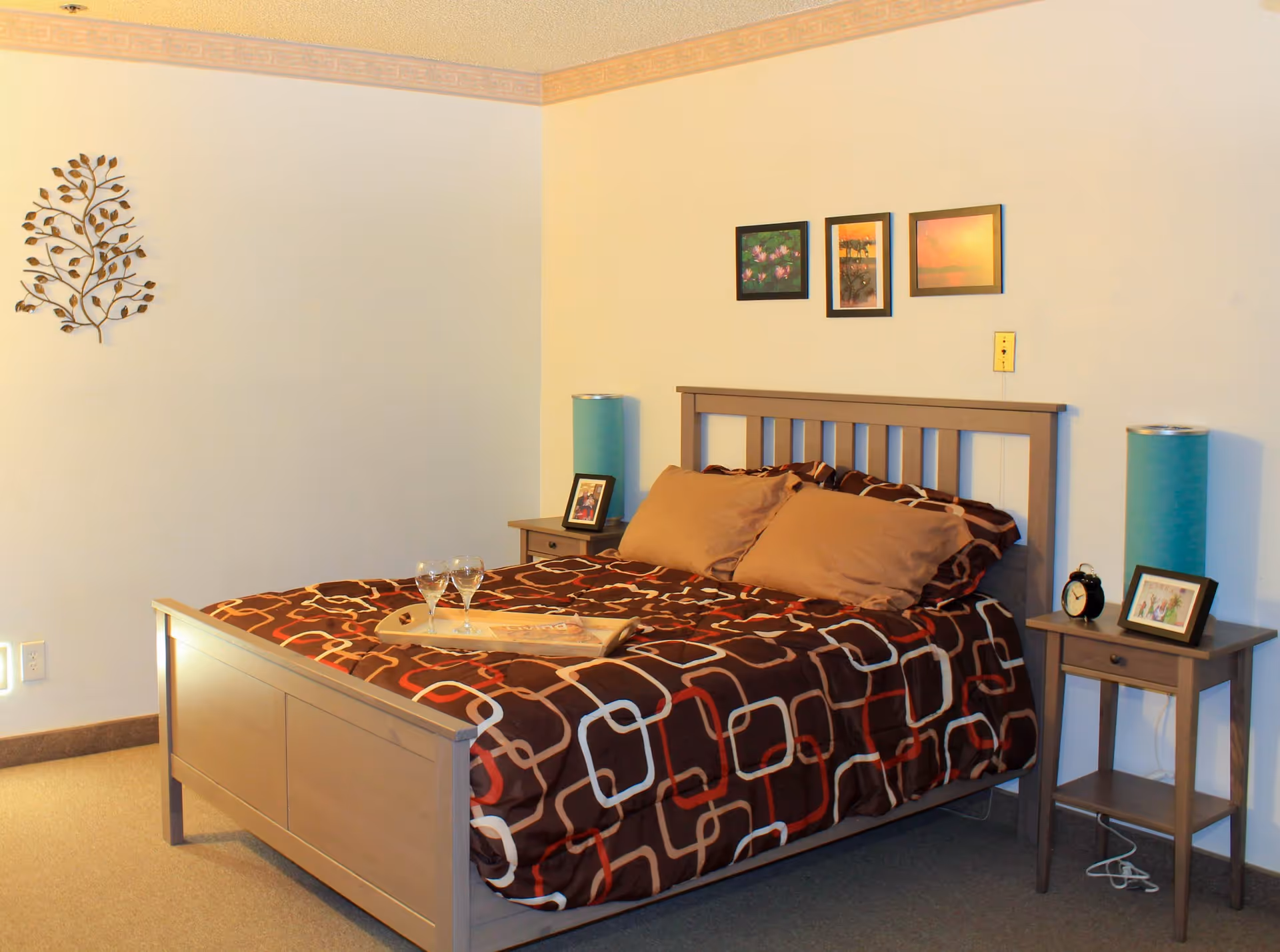 A neatly made bedroom with a wooden bed, side tables, and lamps.