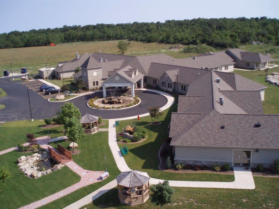 Aerial view of Niagara Hospice campus with circular driveway, connected buildings, and landscaped grounds.