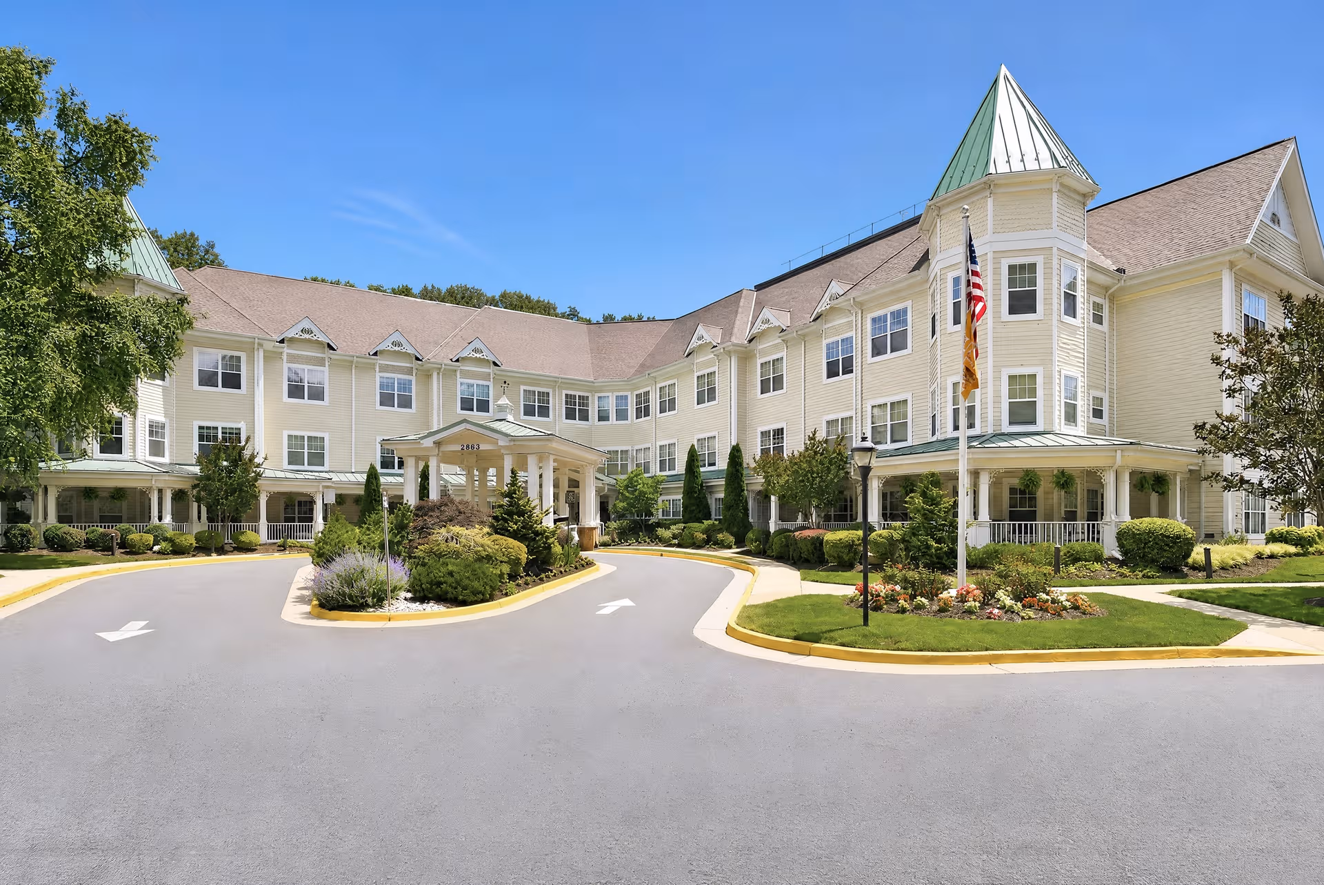 Exterior view of Sunrise at Hunter Mill facility with curved driveway and landscaped entrance.