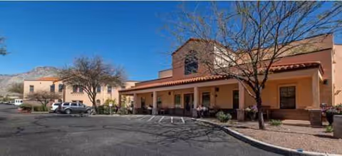 Front exterior of AristaCare at Meadow Springs, featuring a covered entrance and parking lot.