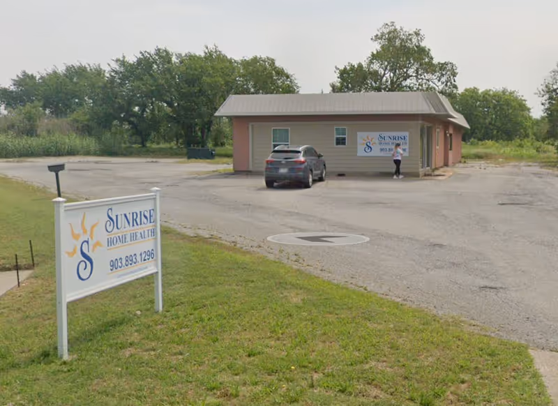 Exterior view of Sunrise Home Health Care building with sign and parking.