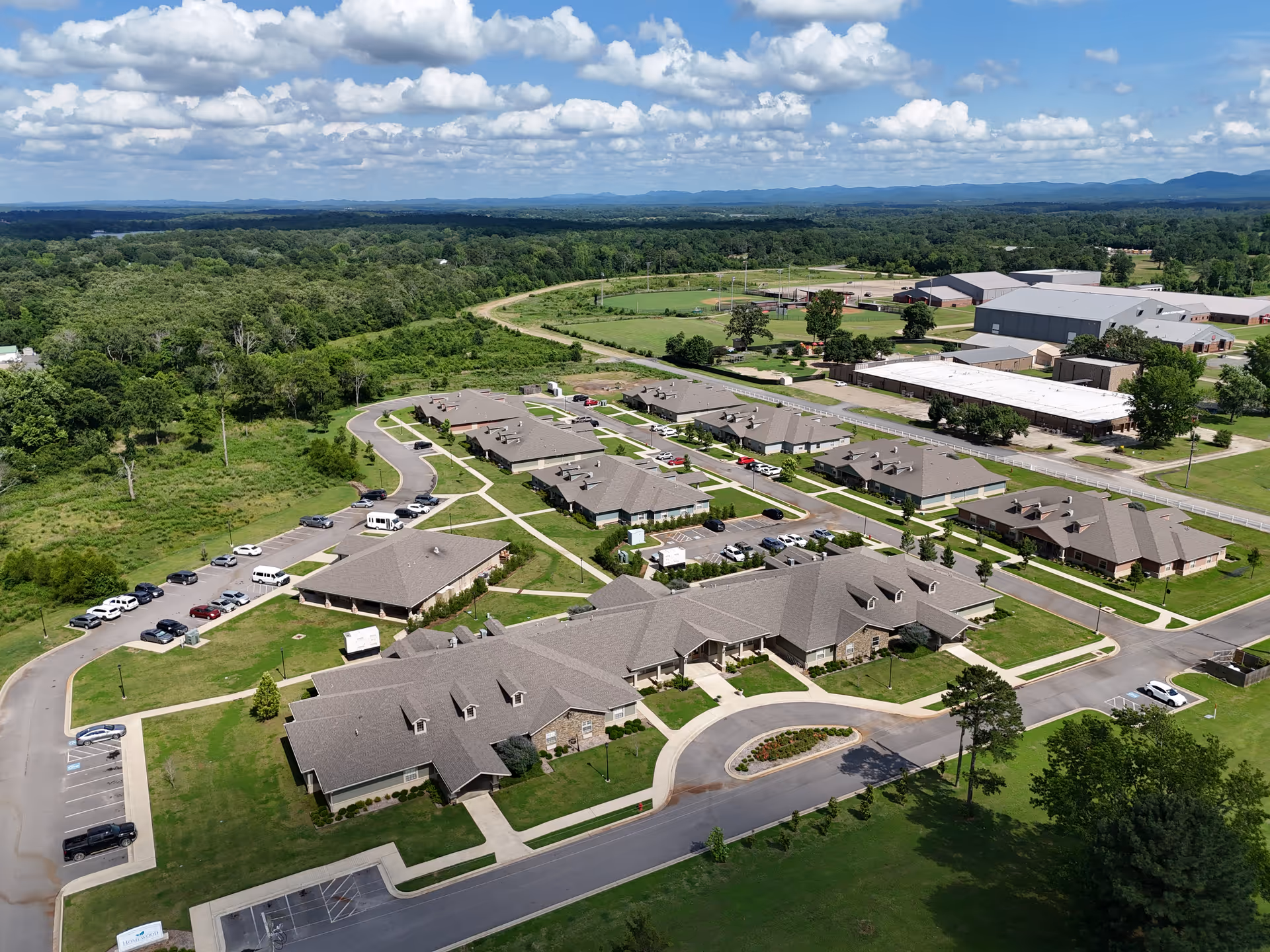 Aerial view of Rich Mountain Nursing and Rehabilitation Center campus with multiple buildings and green grounds