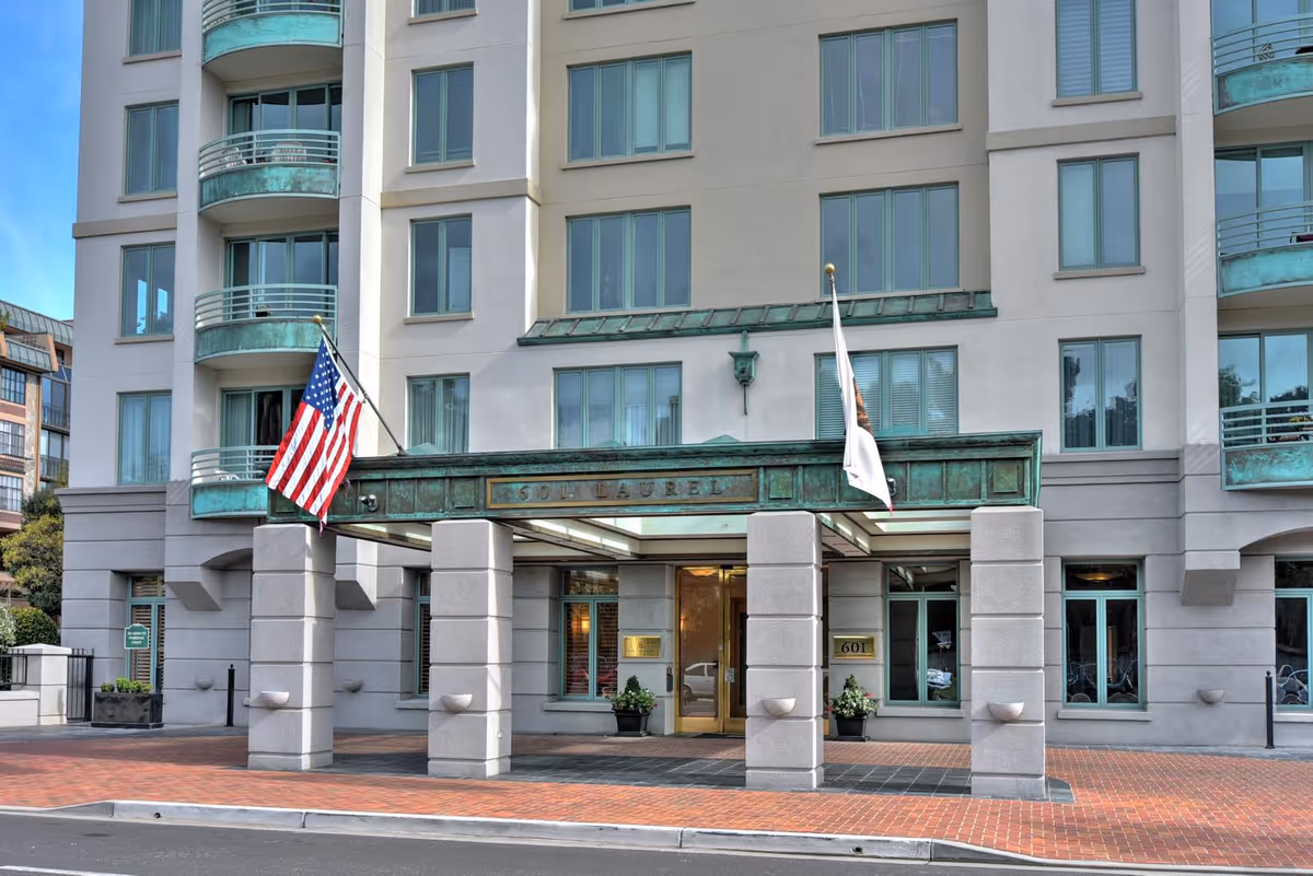 The Stratford building front with a covered entrance and American flag.