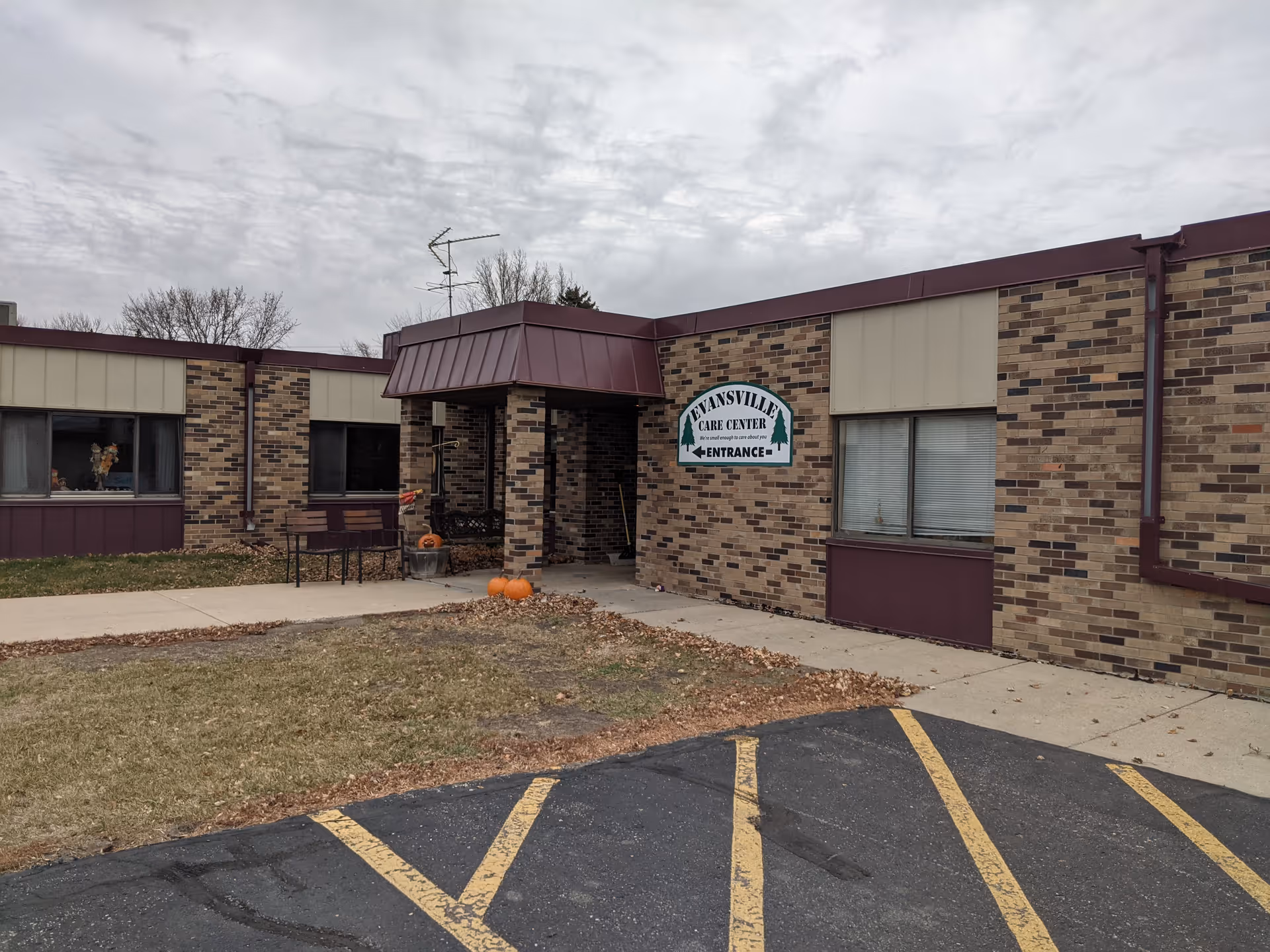 Exterior view of Evansville Care Center entrance with pumpkins on the walkway