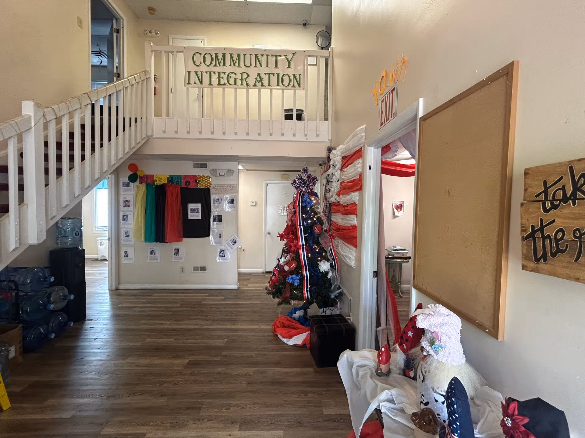 Indoor common area with a balcony sign reading Community Integration and festive Christmas decorations.