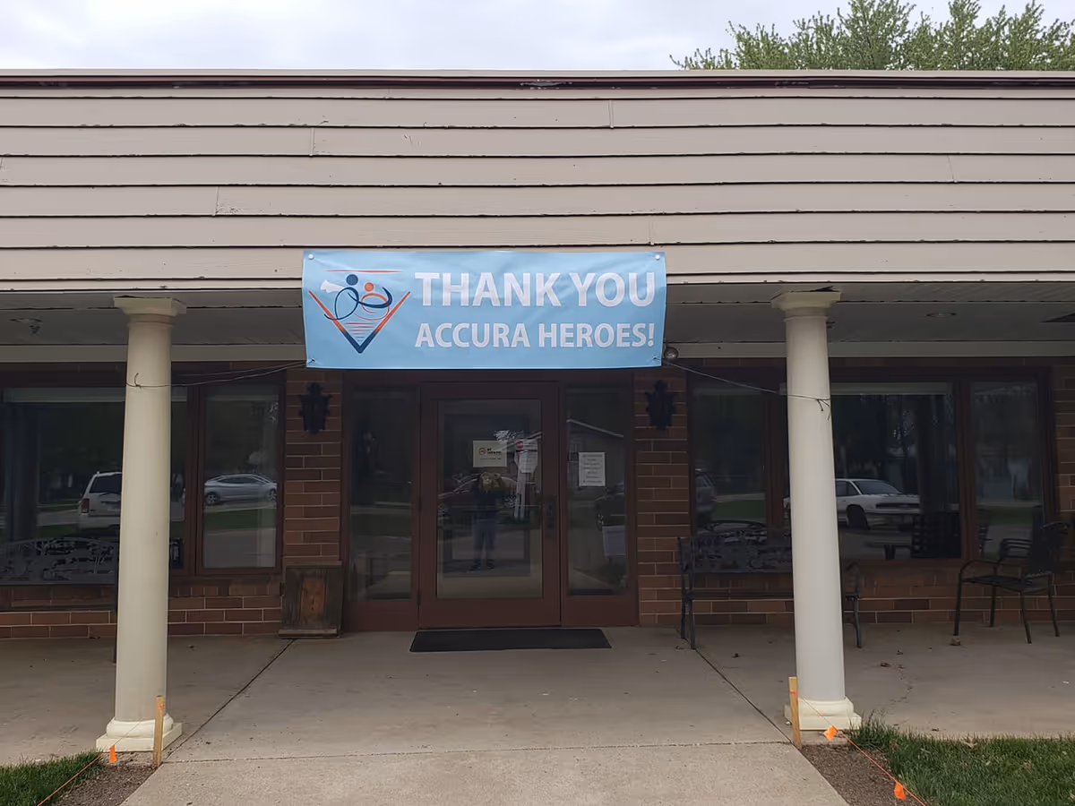 Front entrance of Accura Healthcare of Milford with a thank-you banner overhead.