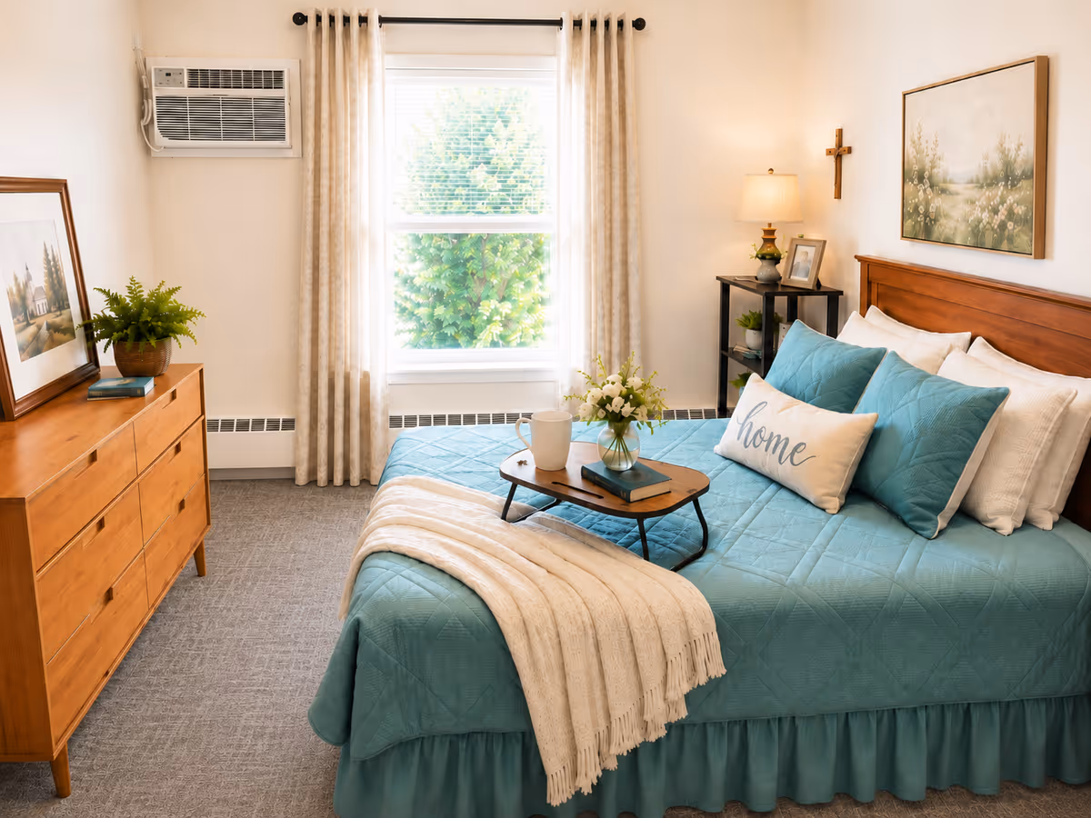 Cozy bedroom with teal bedspread, plants, and framed art in a senior living facility.