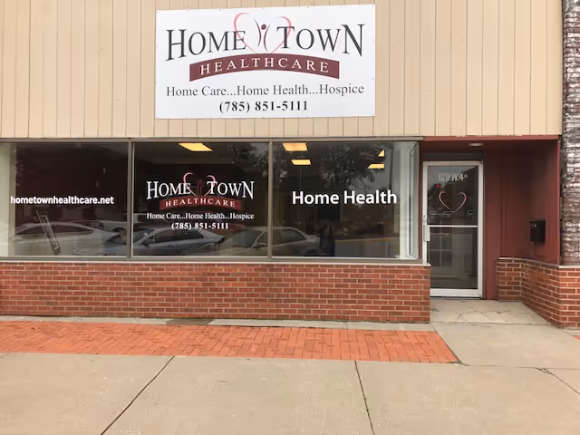 Front of a beige brick storefront with a prominent Home Town Healthcare sign.