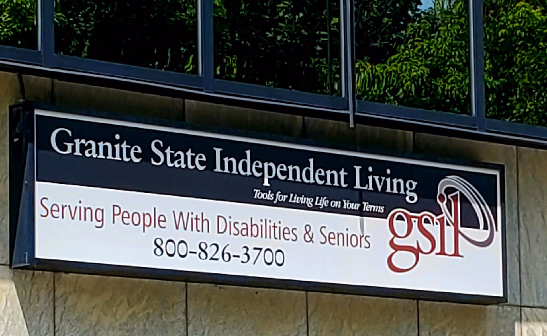 Exterior building sign displays Granite State Independent Living (GSIL) and contact number.