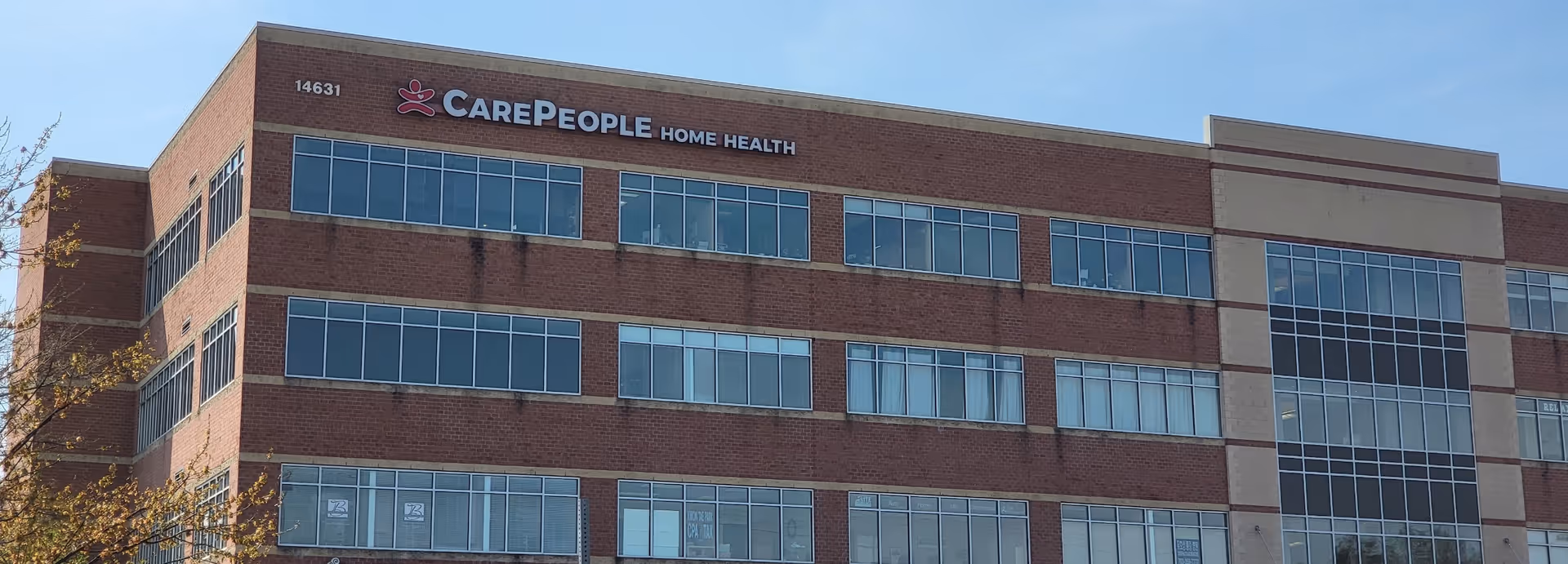 Brick multi-story building with large windows and CarePeople Home Health sign on the facade