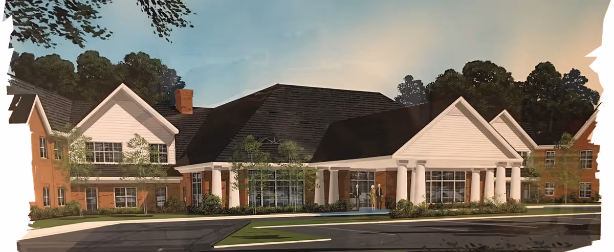 Front exterior rendering of a brick senior living building with white columns, pitched roofs, and a driveway in front.