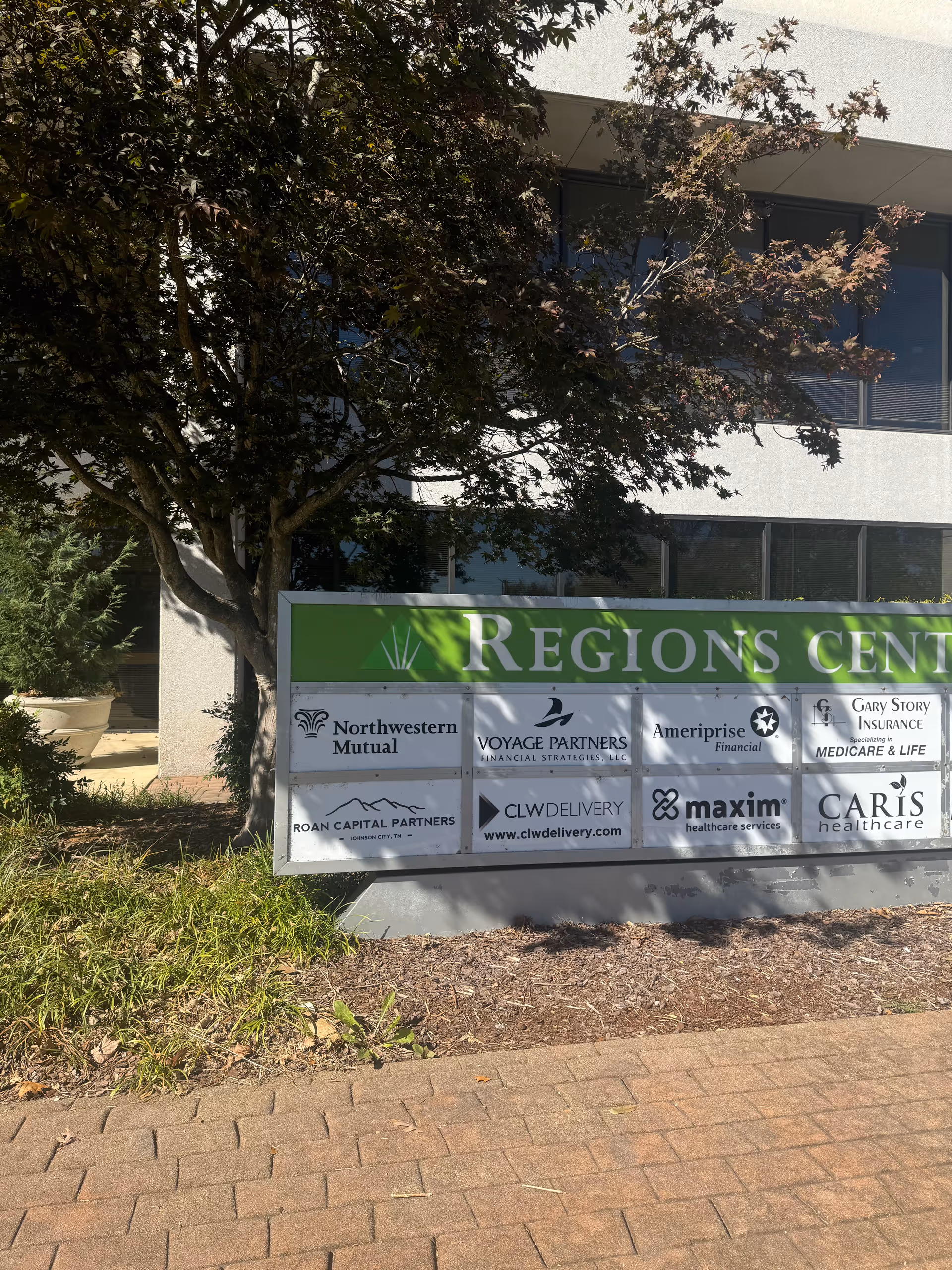 Exterior view of a building with a large green Regions Center sign and sponsor logos.