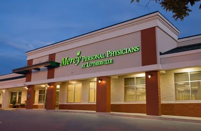 Exterior of Mercy Personal Physicians at Lutherville with an illuminated green sign.