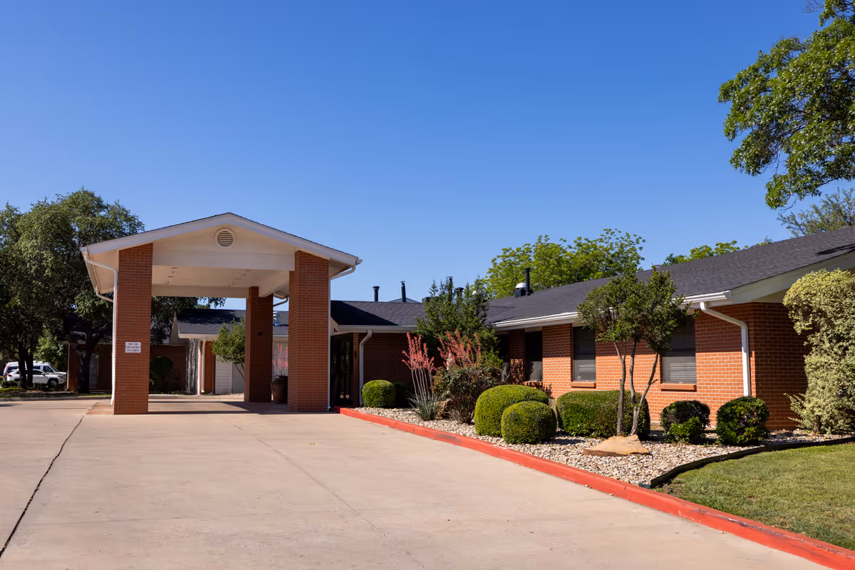 Wisteria Place Nursing and Rehabilitation exterior with brick entry and manicured landscaping.