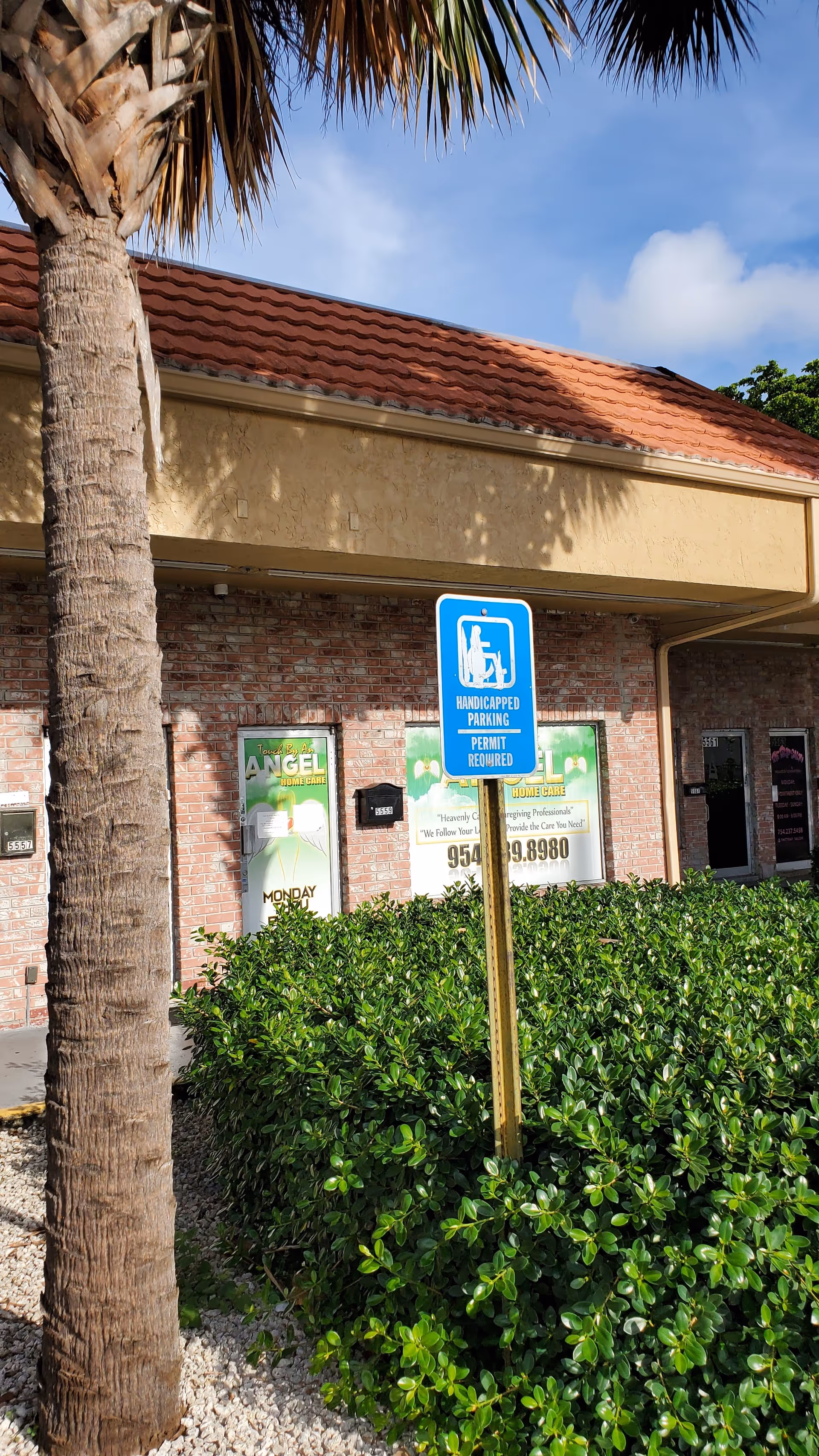Exterior view of Touch by an Angel Home Care building with a blue handicap parking sign.