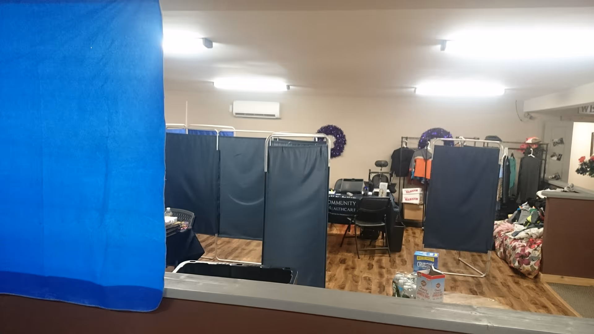 Indoor care area with blue privacy curtains and partition screens