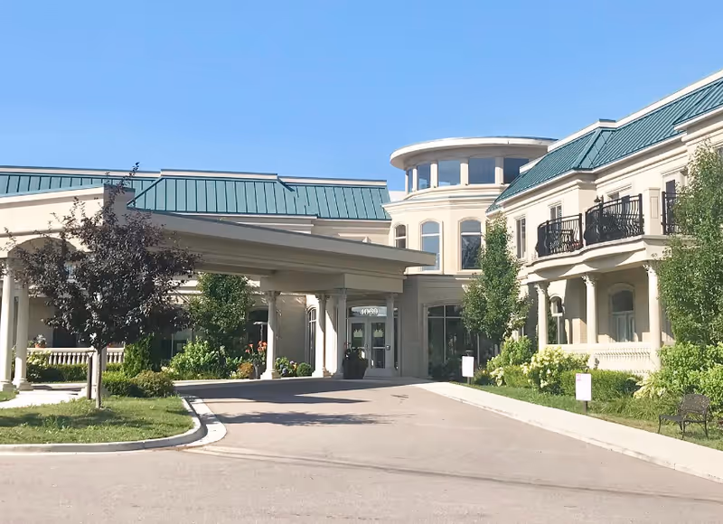 Exterior view of Tranquility Estates with a covered entrance and manicured landscaping.