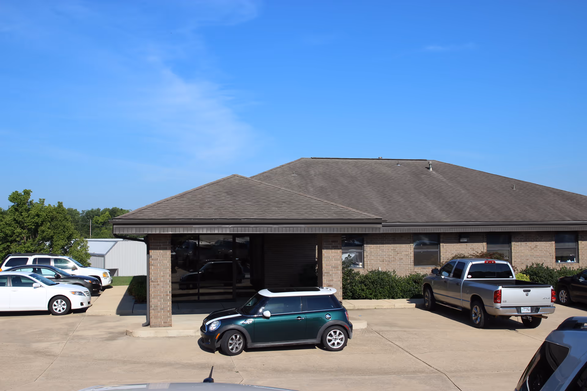 Brick facility with a covered entrance and front parking lot.