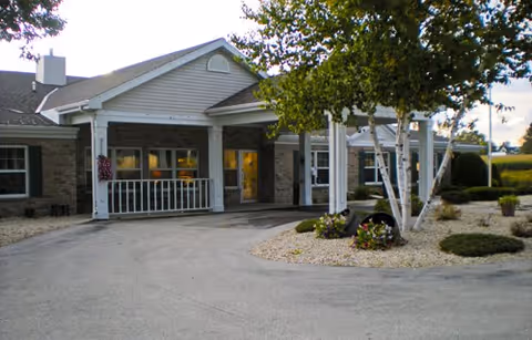 Front exterior view of Meadow View Assisted Living with a covered entrance and landscaping.