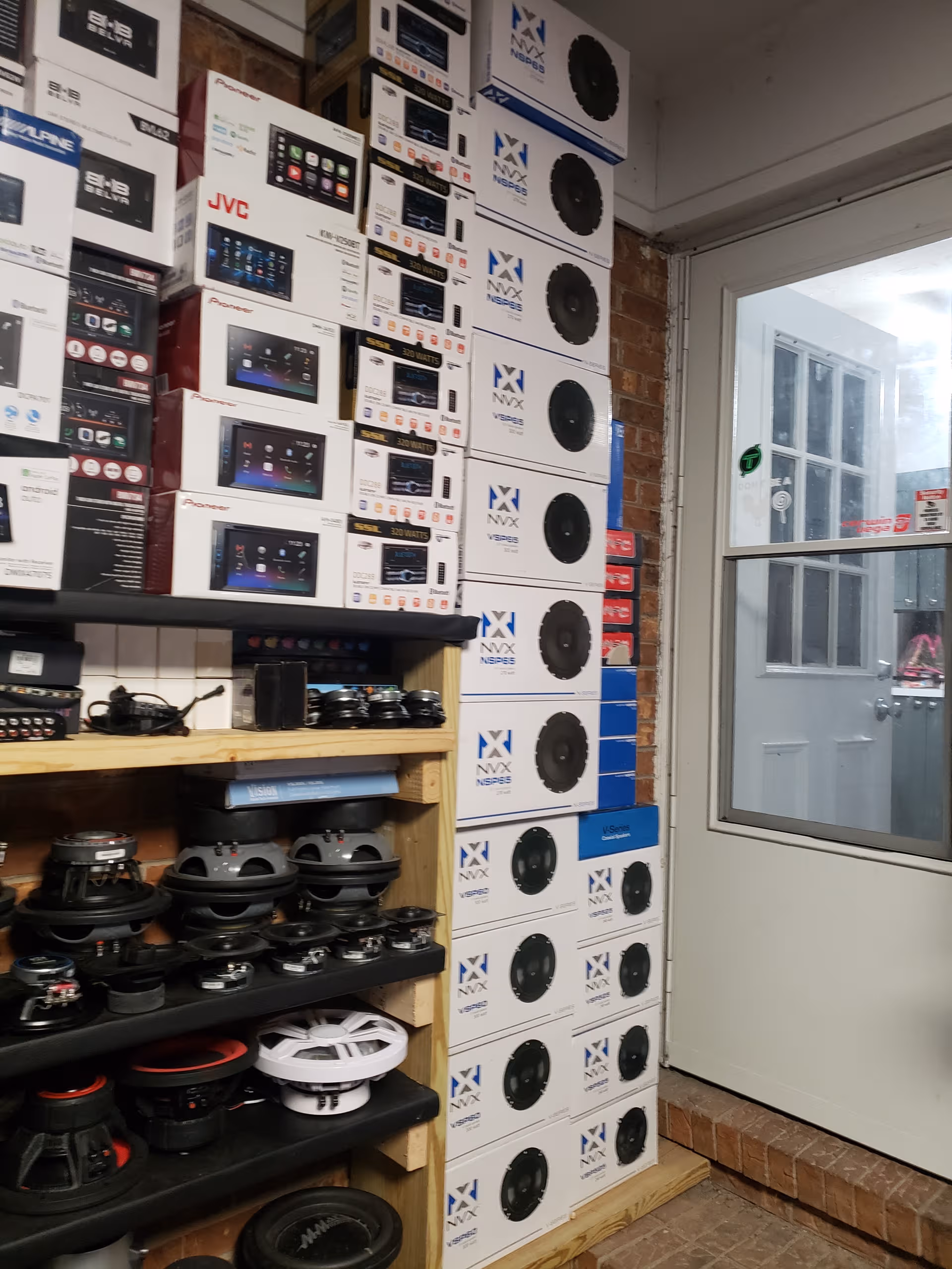 Inside Mt Olive Family Care Home storage room with stacked speaker boxes and shelves.