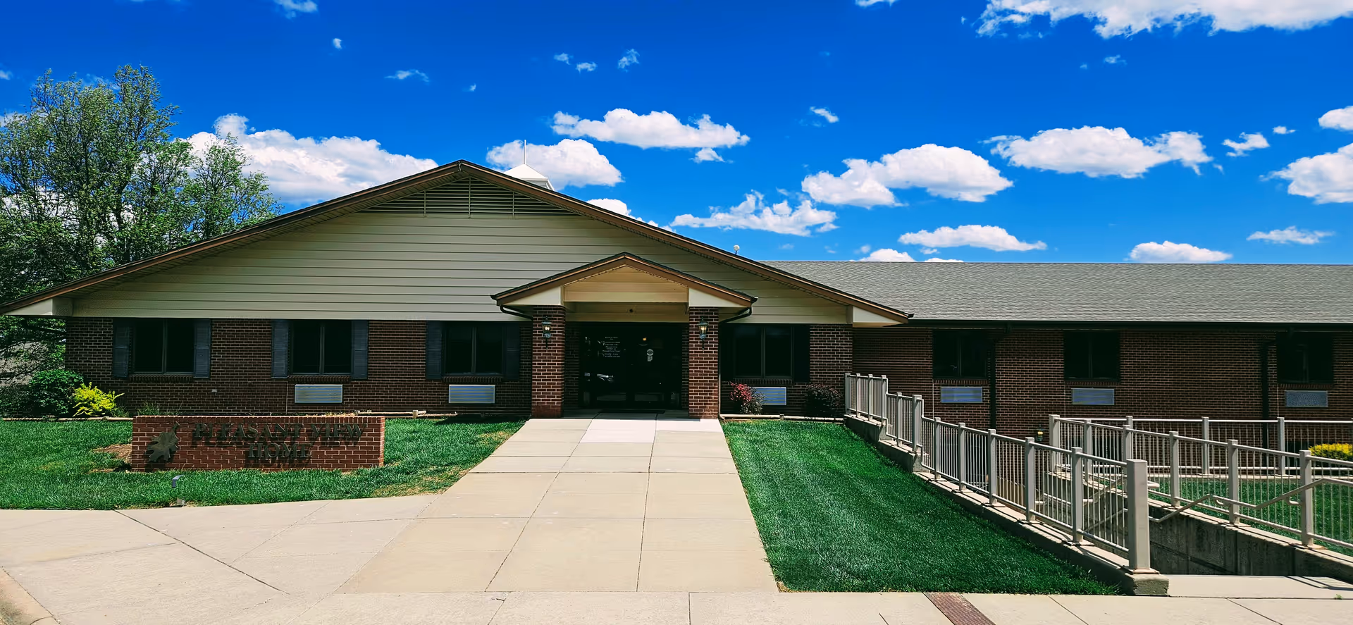 Front view of Pleasant View Home senior living facility with brick exterior and accessible ramp