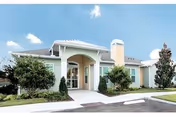 Front exterior view of a single-story senior care facility with landscaped entrance.