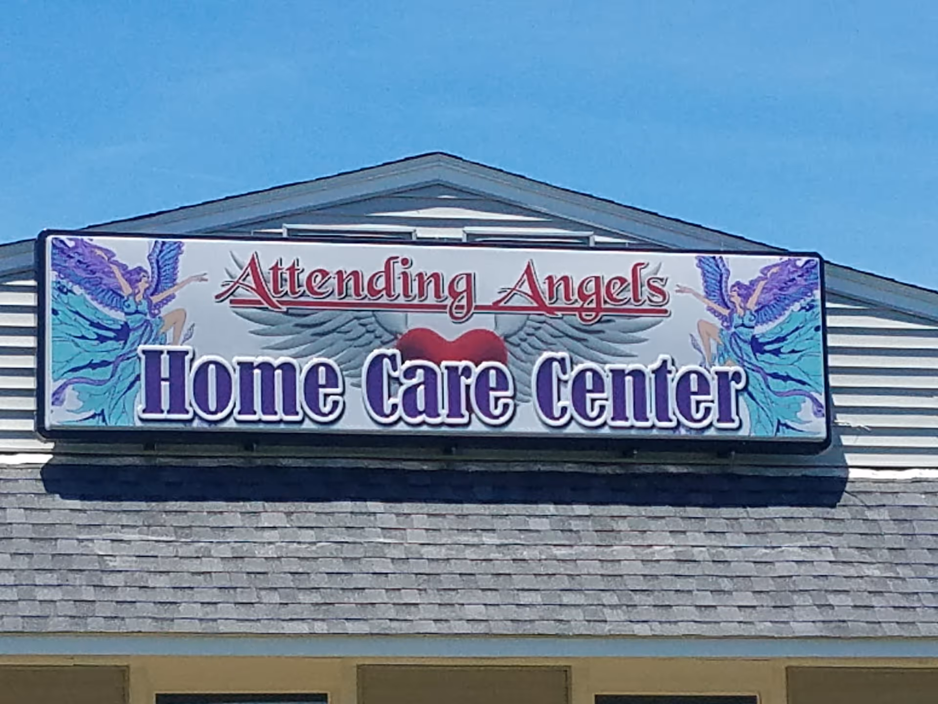 Exterior view of a building with a large sign reading Attending Angels Home Care Center