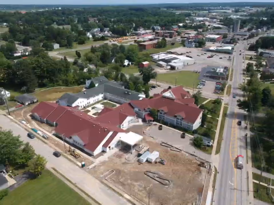 Aerial view of Briar Hill Health Care Residence complex with red-roofed buildings.