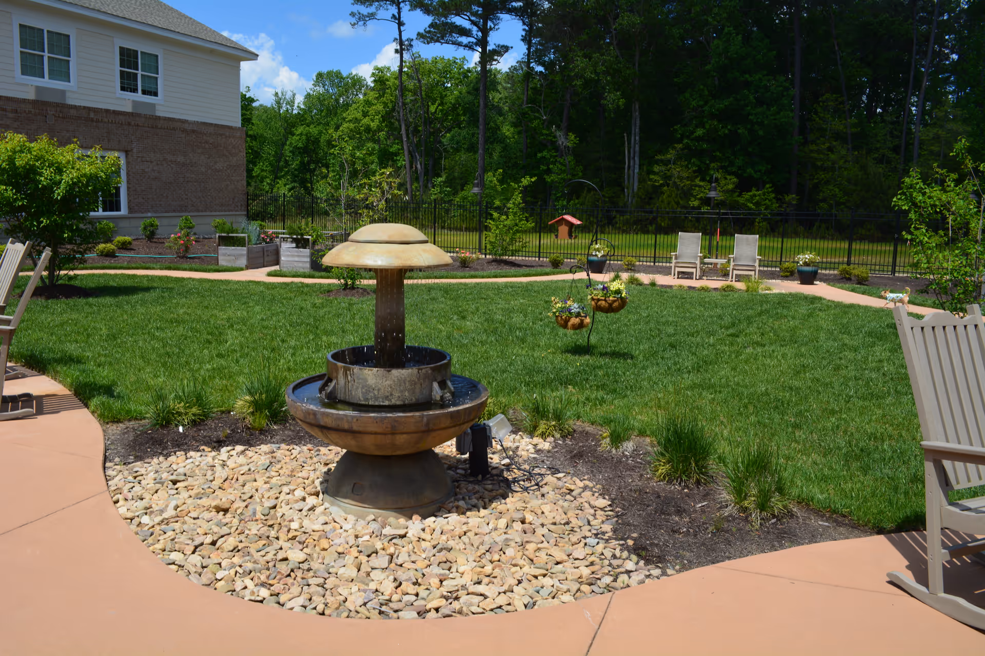Outdoor garden at Edgeworth Park at New Town featuring a fountain, lawn, and seating.