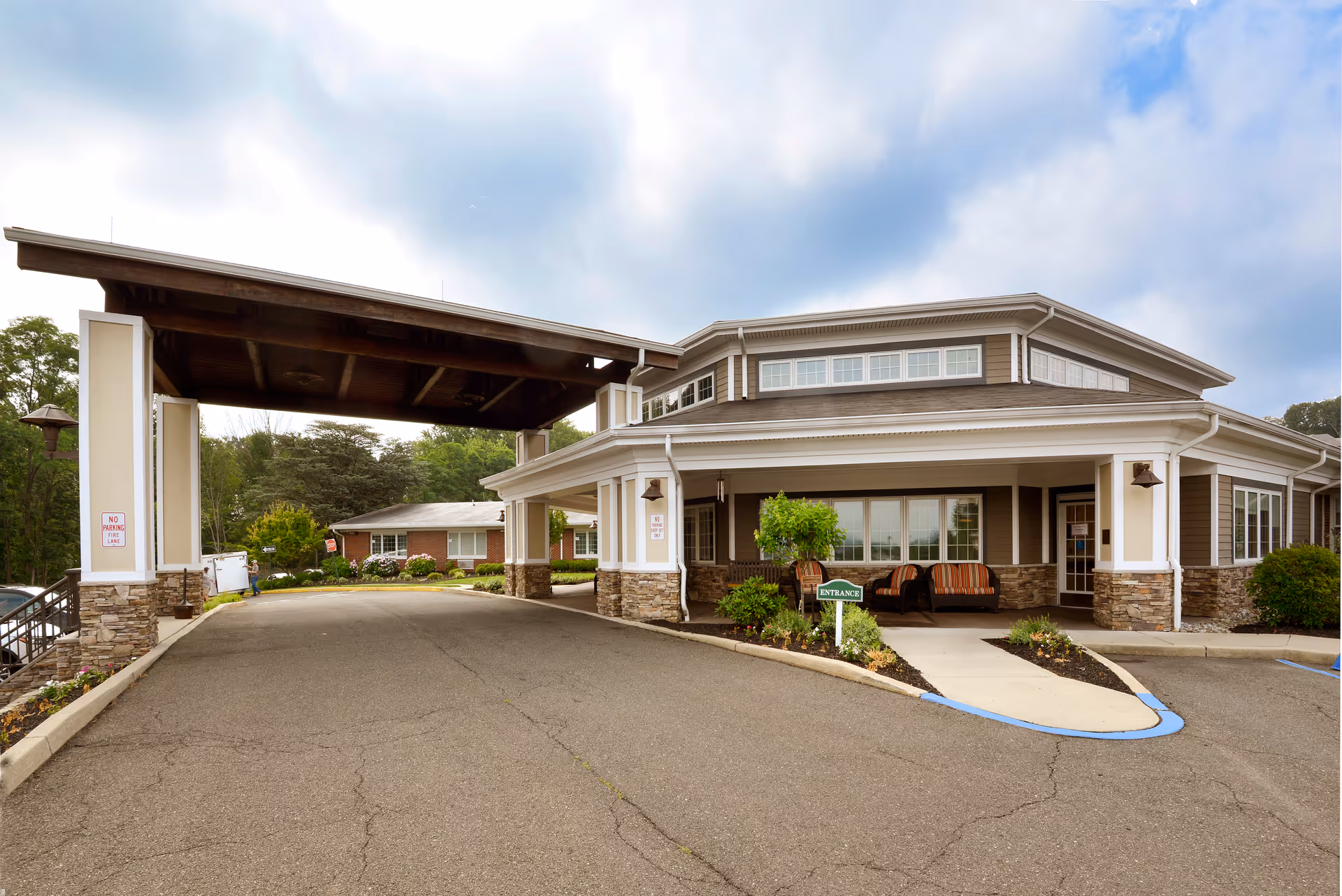 Front view of Heritage Manor, a Christian Health Community, showing a covered driveway and welcoming entrance.