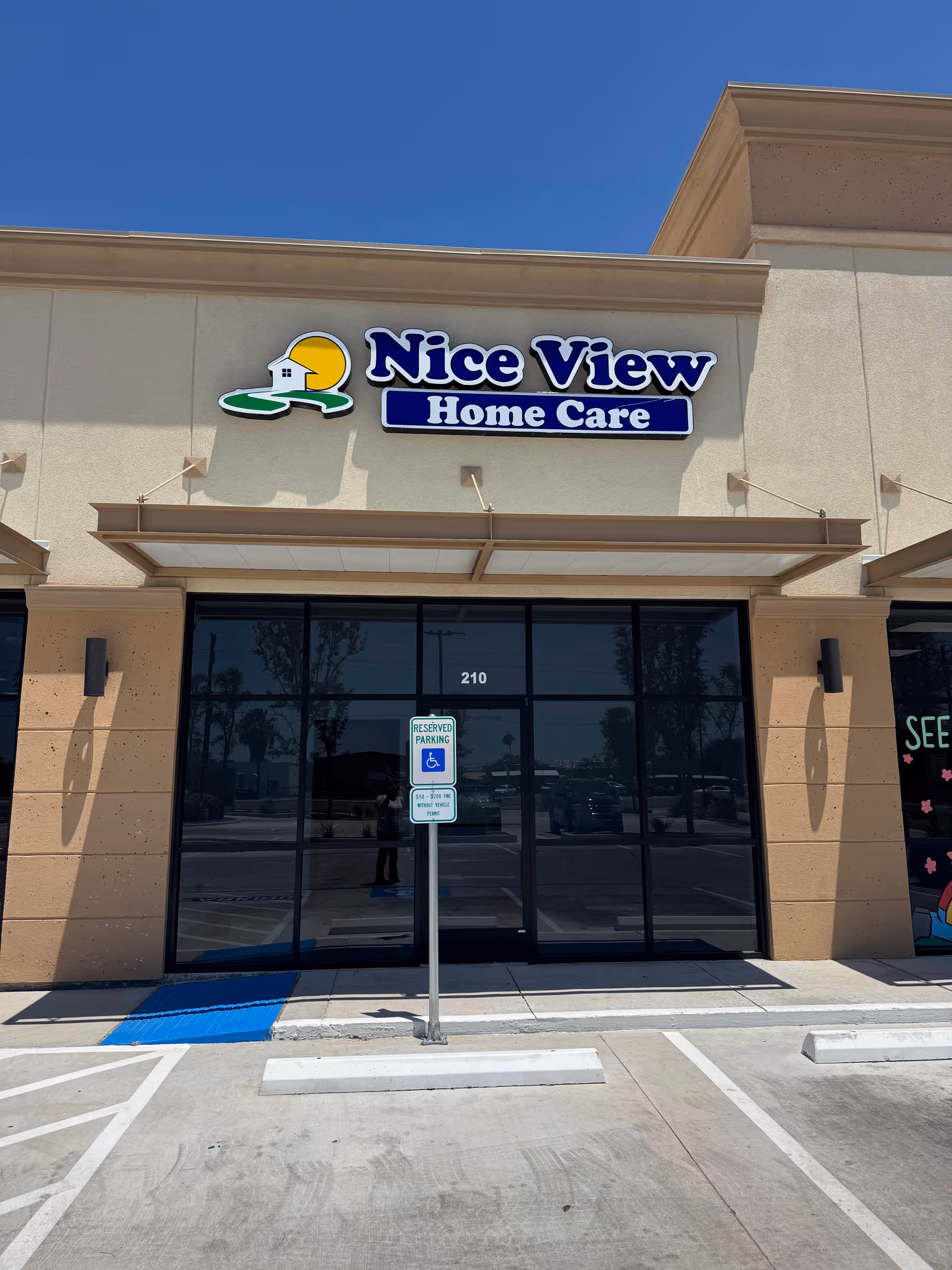 Front view of Nice View Home Care storefront with glass entrance and handicap parking sign