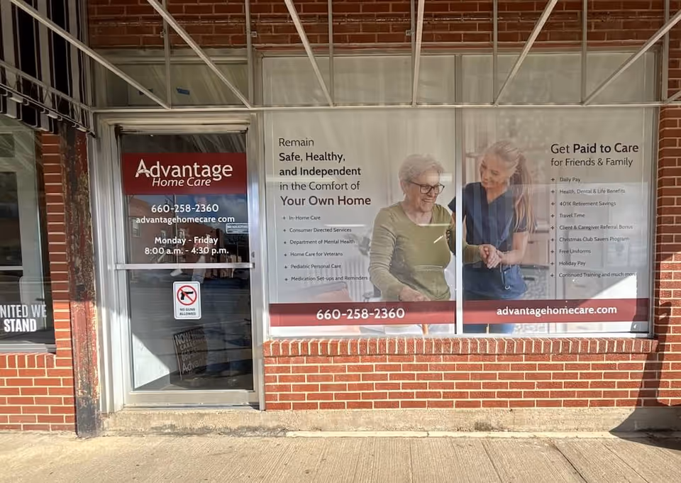 Brick storefront with Advantage Home Care Brookfield MO signage and glass door