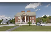 Lincoln House senior living building with columns, lawn, and parked cars.