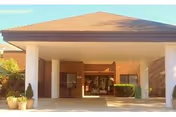 Front view of Springside Rehabilitation and Skilled Care Center entrance with brick facade and columns.