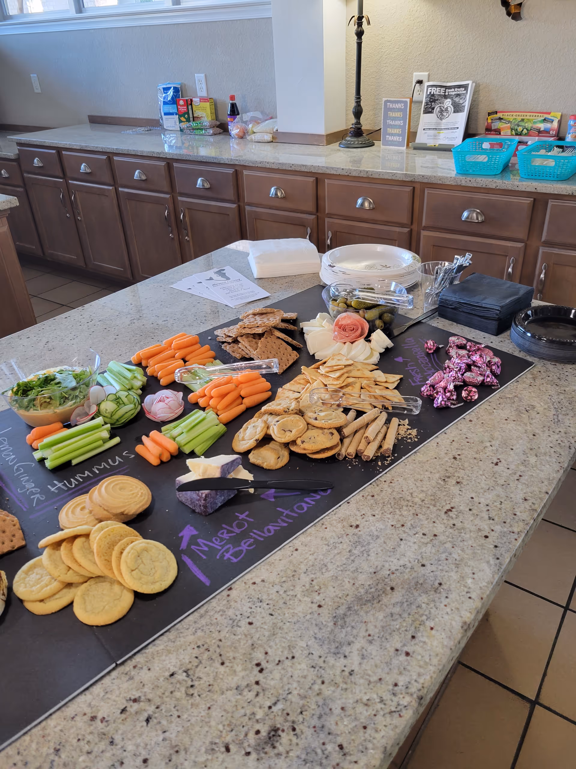 A kitchen island with a colorful snack spread in a senior living facility.