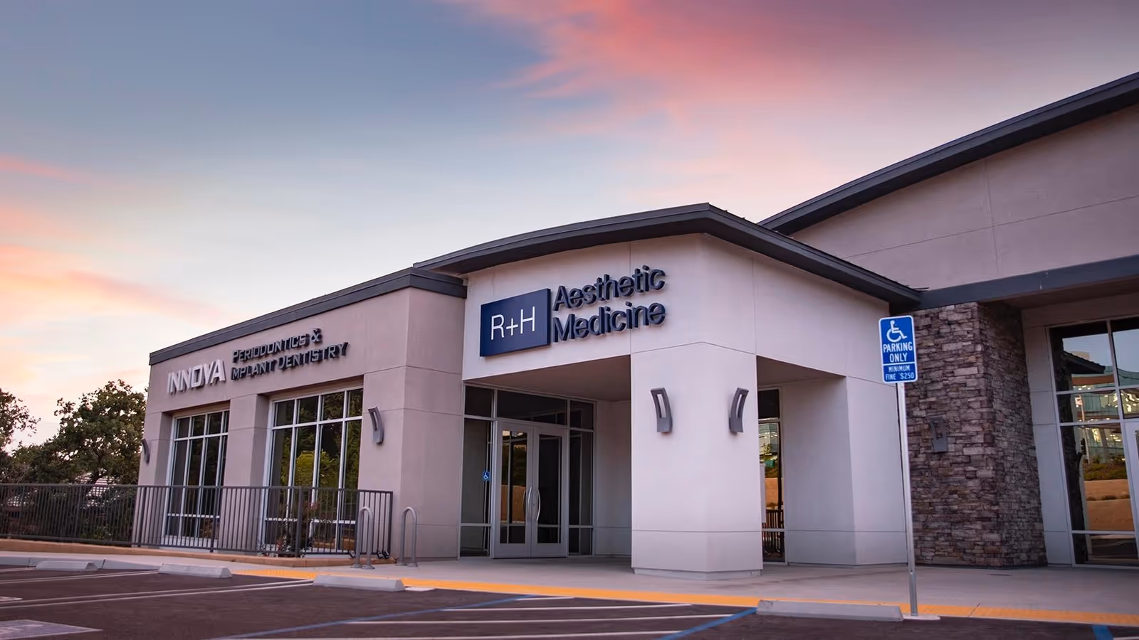 Front facade of a modern medical clinic labeled R+H Aesthetic Medicine.