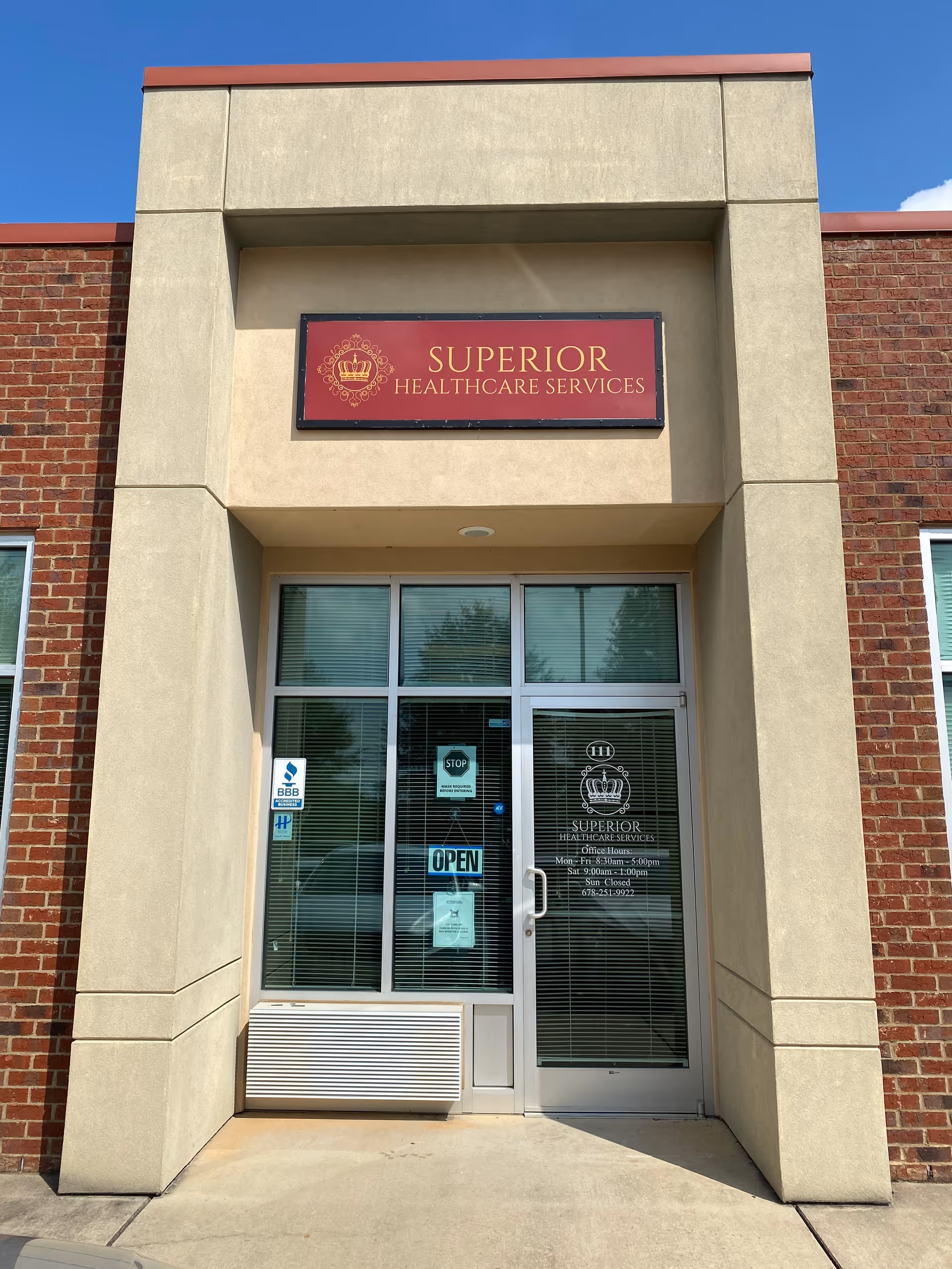 Front entrance of Superior Healthcare Services building with brick walls and glass doors.