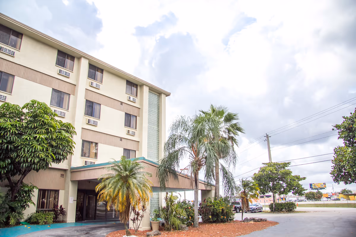 Exterior view of Waterford Rehab & Nursing Center entrance with palm trees