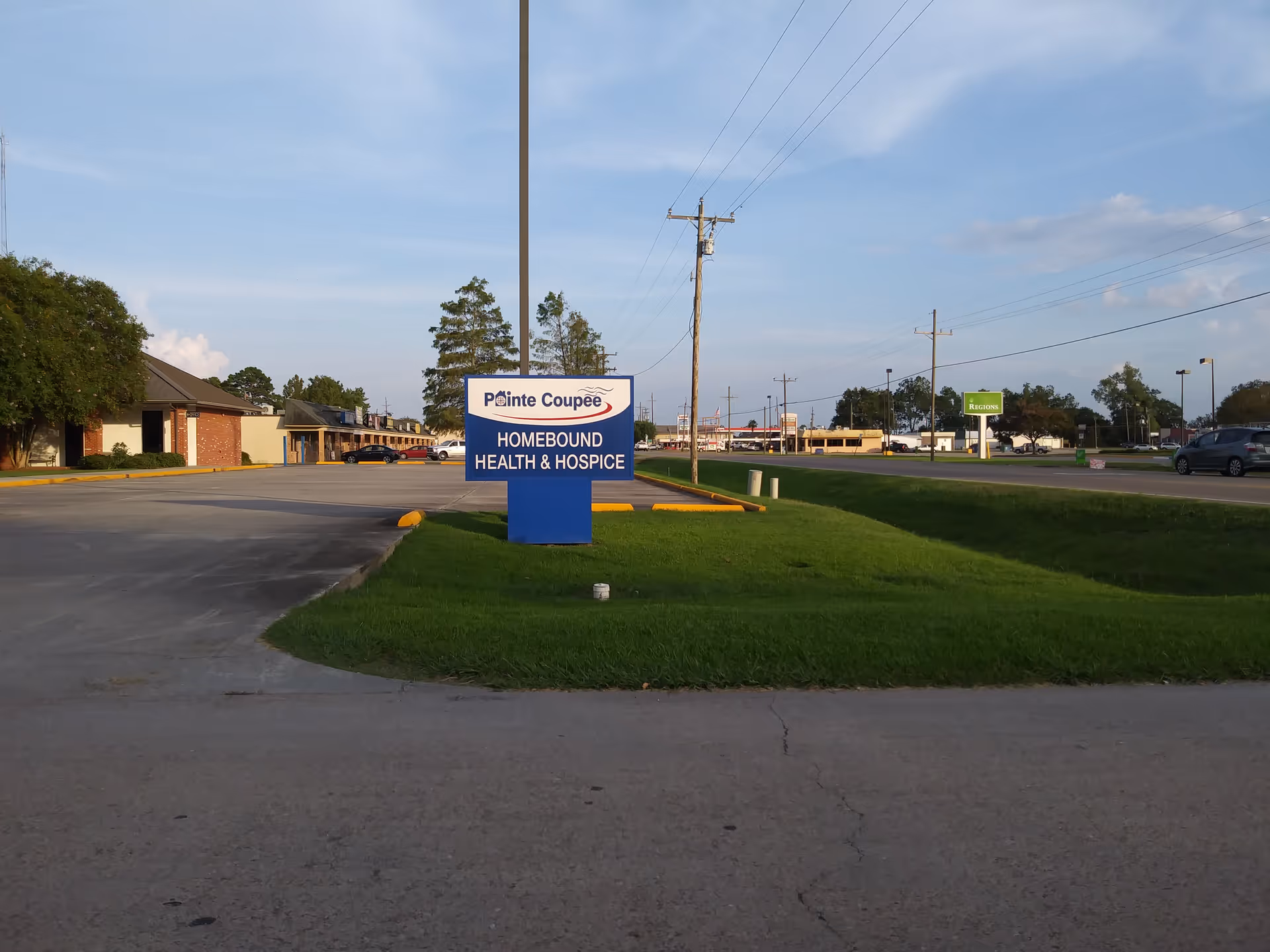 Blue Pointe Coupee sign for Homebound Health and Hospice in a parking lot.