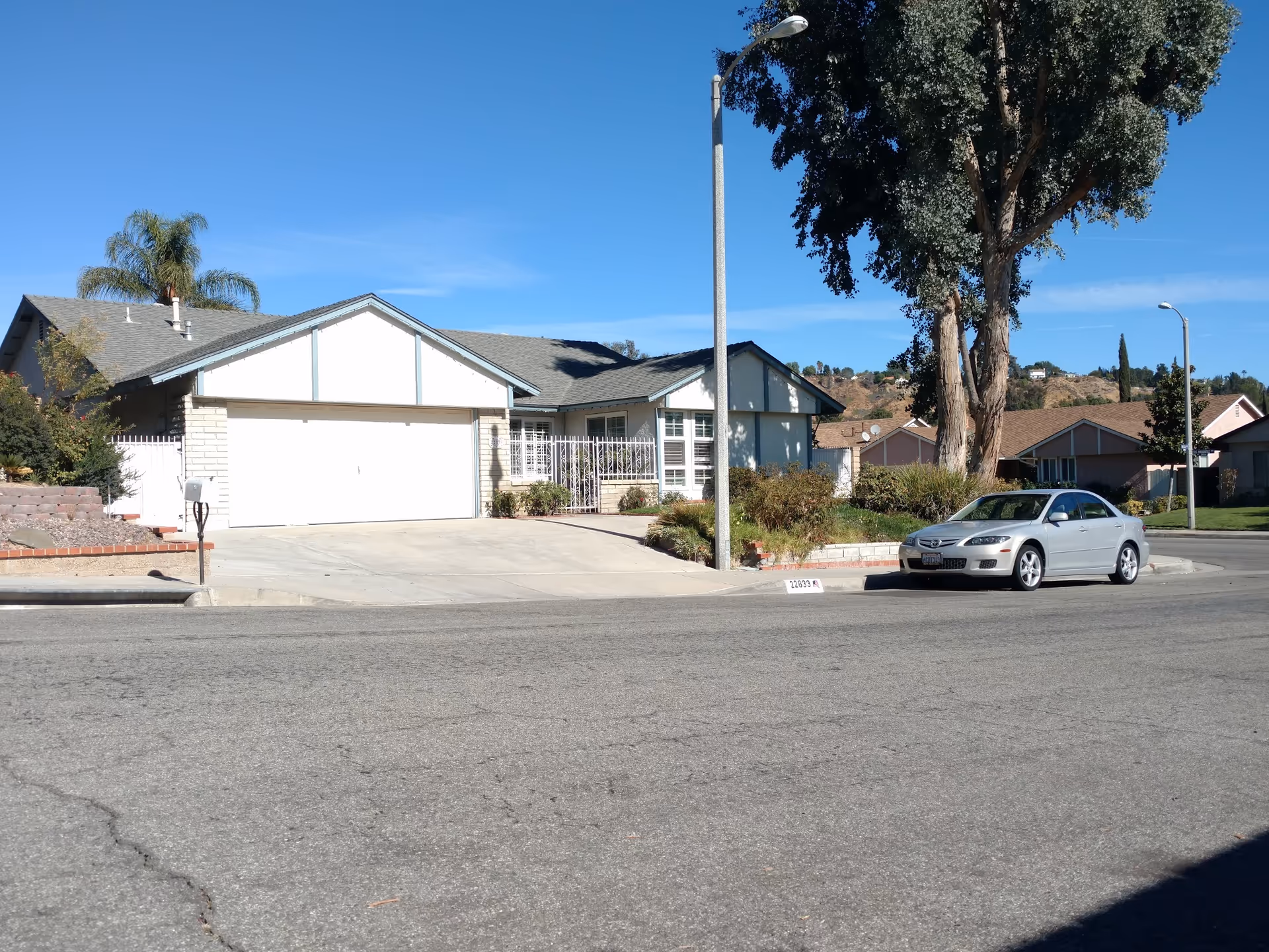 Residential, single-story home with garage and driveway on a suburban street