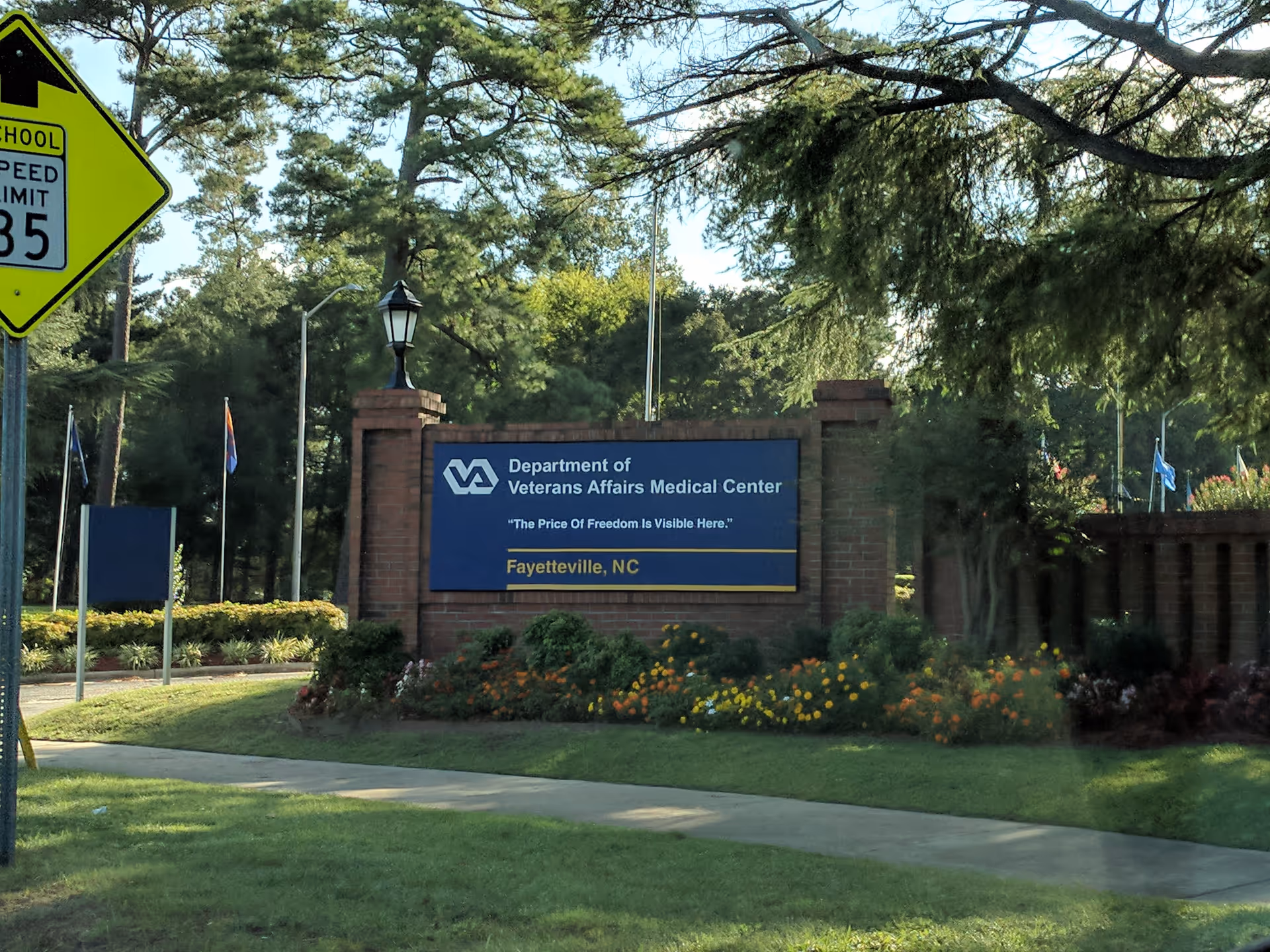 Front view of Fayetteville VA Medical Center entrance sign with brick pillars and landscaping.